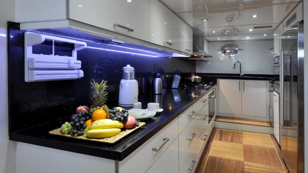 Modern kitchen on a luxurious gulet. You can see exotic fruits